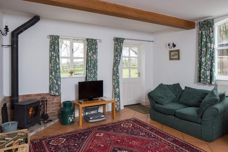 The sitting/dining-room welcomes you to the cottage, the wood-burner is perfect for a cosy evening in.