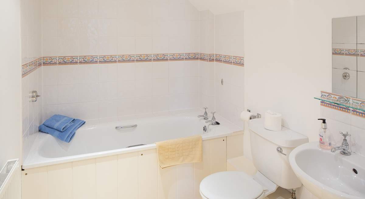 The en suite bathroom is spacious and light.