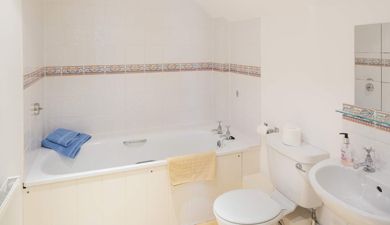 The en suite bathroom is spacious and light.