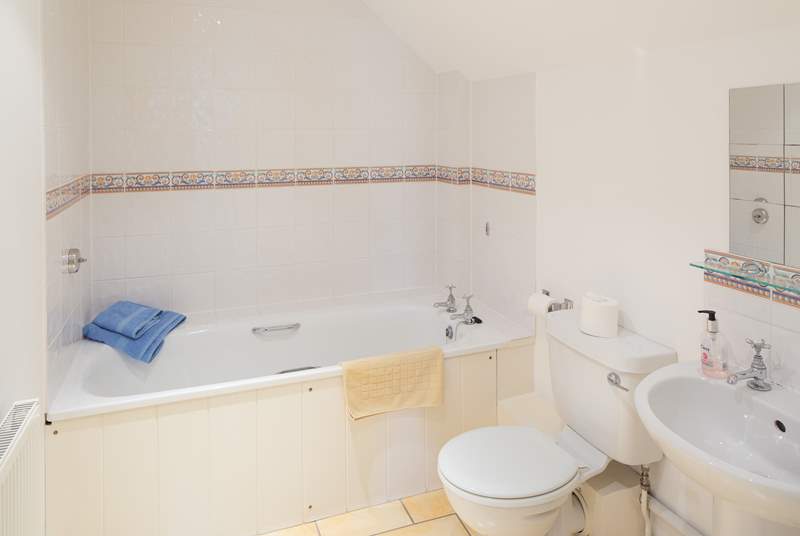 The en suite bathroom is spacious and light.