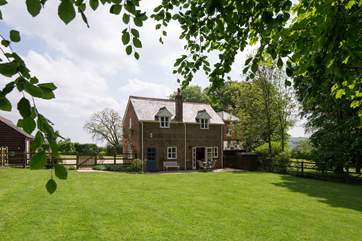The cottage looks out onto the enclosed garden and has wonderful views, the owner's house is to the right in the background.