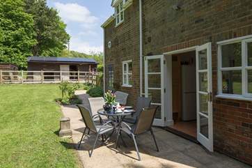 The private terrace at the back of the cottage has French doors that lead into the kitchen, perfect for al fresco dining.