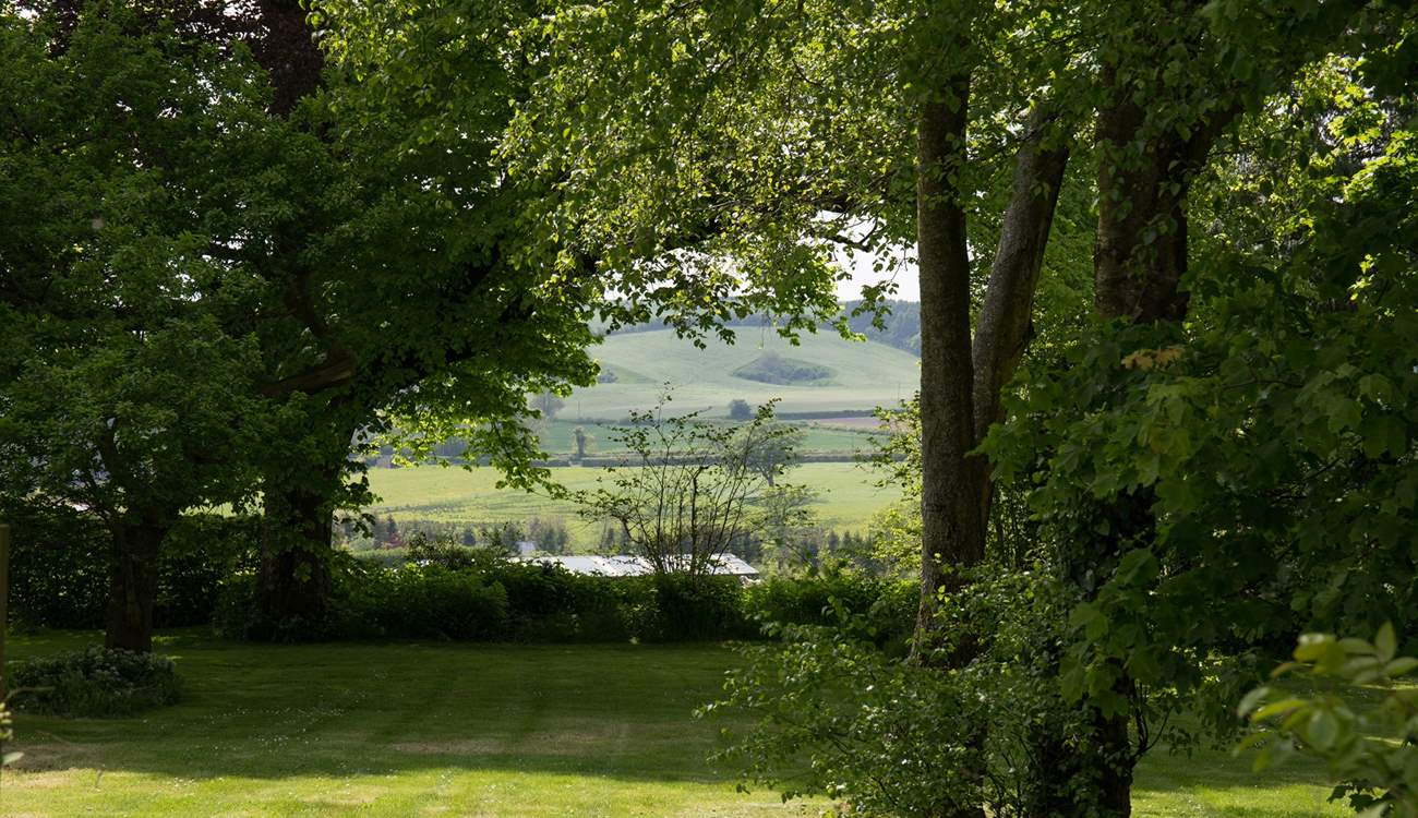 Wonderful views from the private garden through a copse and across the valley.