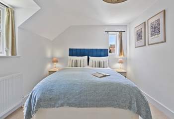 Upstairs, the sumptuous primary bedroom features a king-size bed and en suite bathroom.