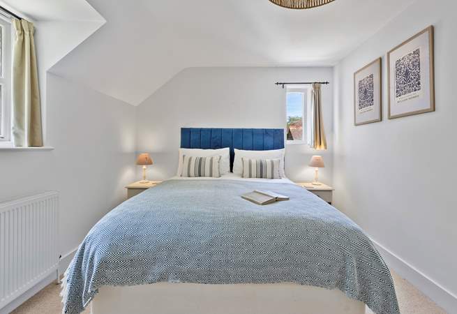 Upstairs, the sumptuous primary bedroom features a king-size bed and en suite bathroom.