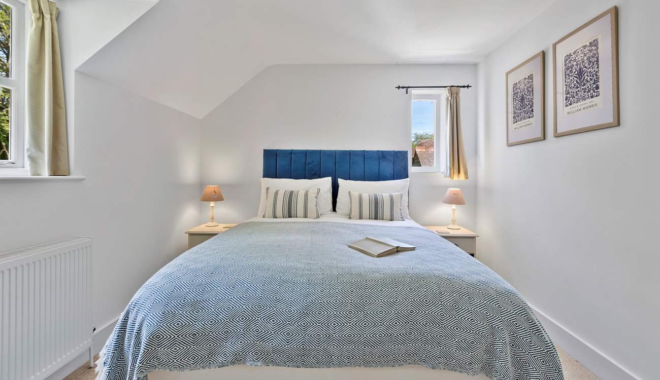 Upstairs, the sumptuous primary bedroom features a king-size bed and en suite bathroom.