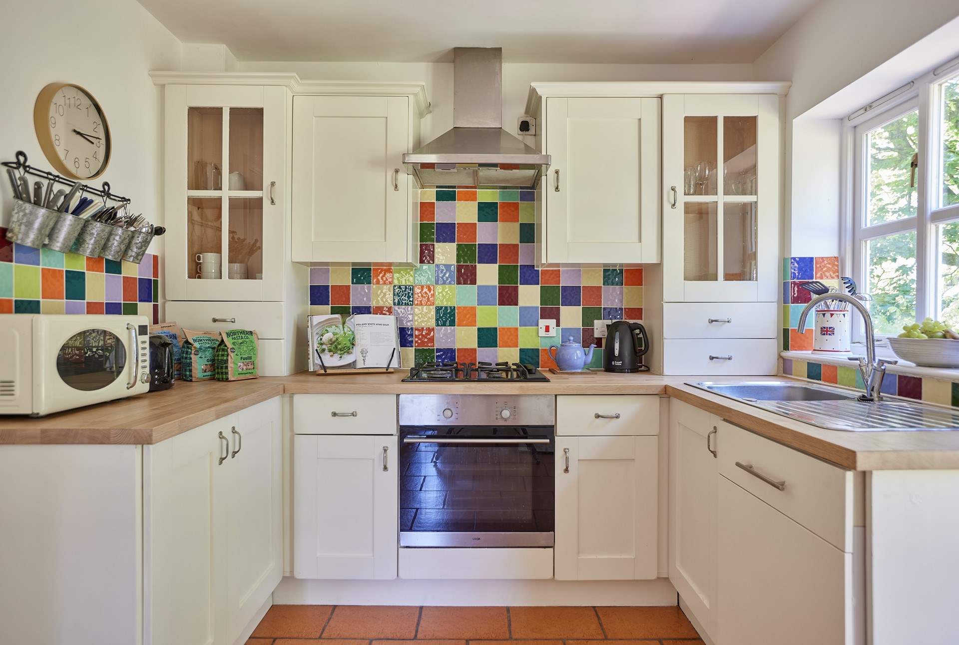 The lovely cottage kitchen is a bright and well equipped space with French doors onto the terrace.