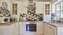 The lovely cottage kitchen is a bright and well-equipped space with French doors onto the terrace.