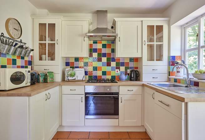 The lovely cottage kitchen is a bright and well-equipped space with French doors onto the terrace.