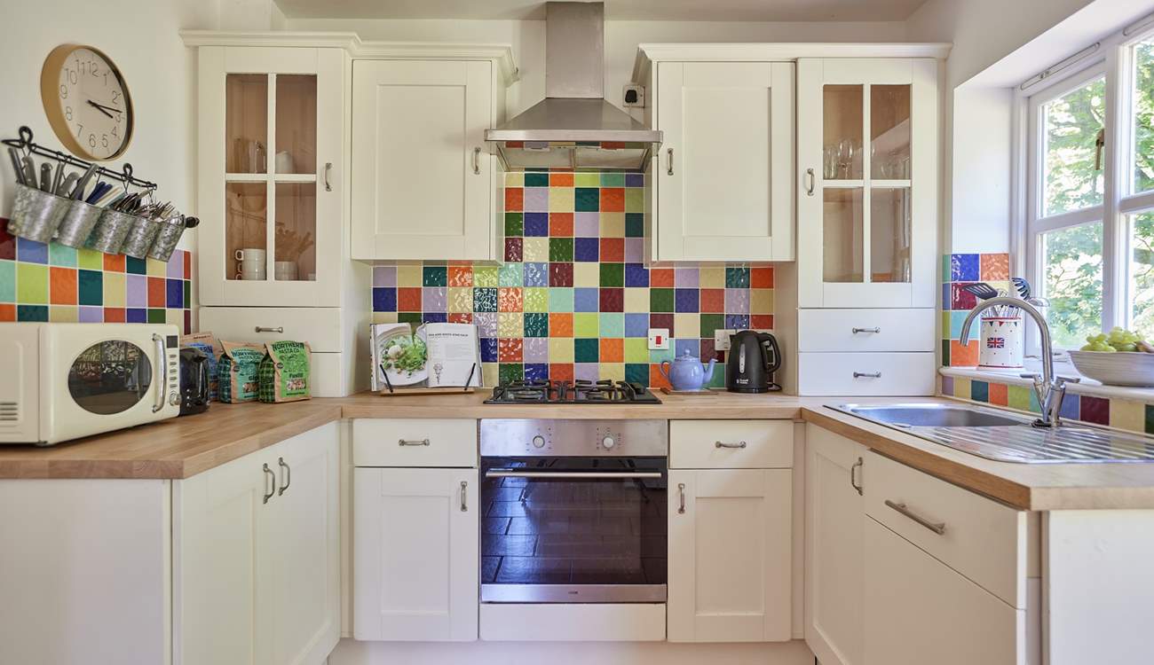 The lovely cottage kitchen is a bright and well-equipped space with French doors onto the terrace.