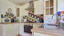 The pretty kitchen is off the sitting-room and overlooking the garden.