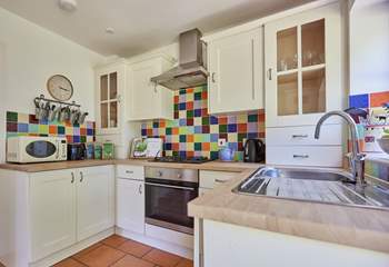 The pretty kitchen is off the sitting-room and overlooking the garden.