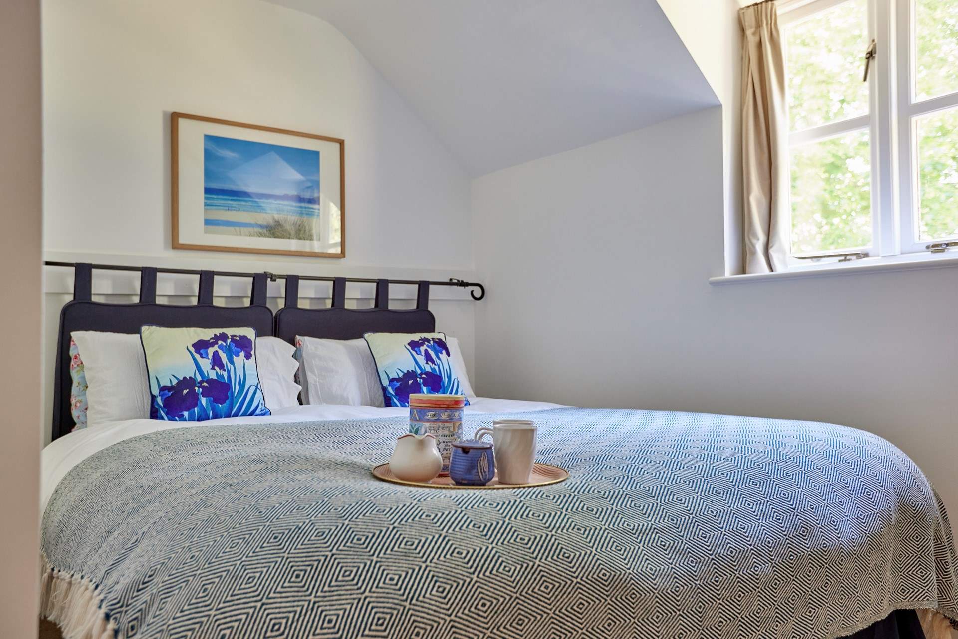 Bedroom two has a lovely view over the garden and features a zip and link king size bed that can be split into two singles to suit.