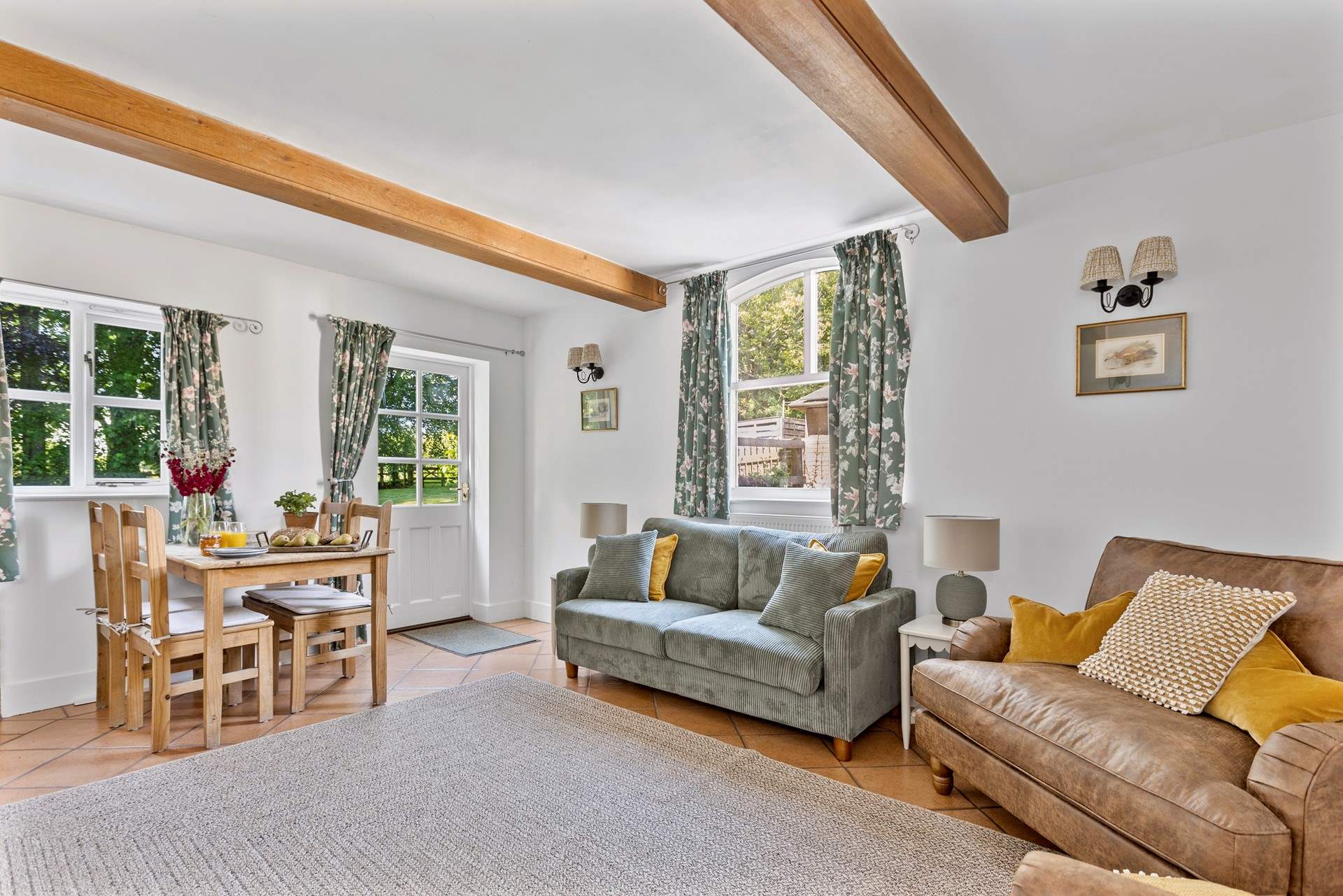 The chic dual aspect sitting room has plenty of room for four and an intimate dining space.
