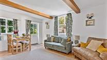 The chic dual aspect sitting-room has plenty of room for four and an intimate dining space.