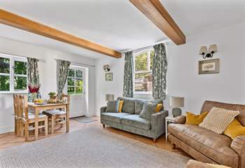 The chic dual aspect sitting-room has plenty of room for four and an intimate dining space.