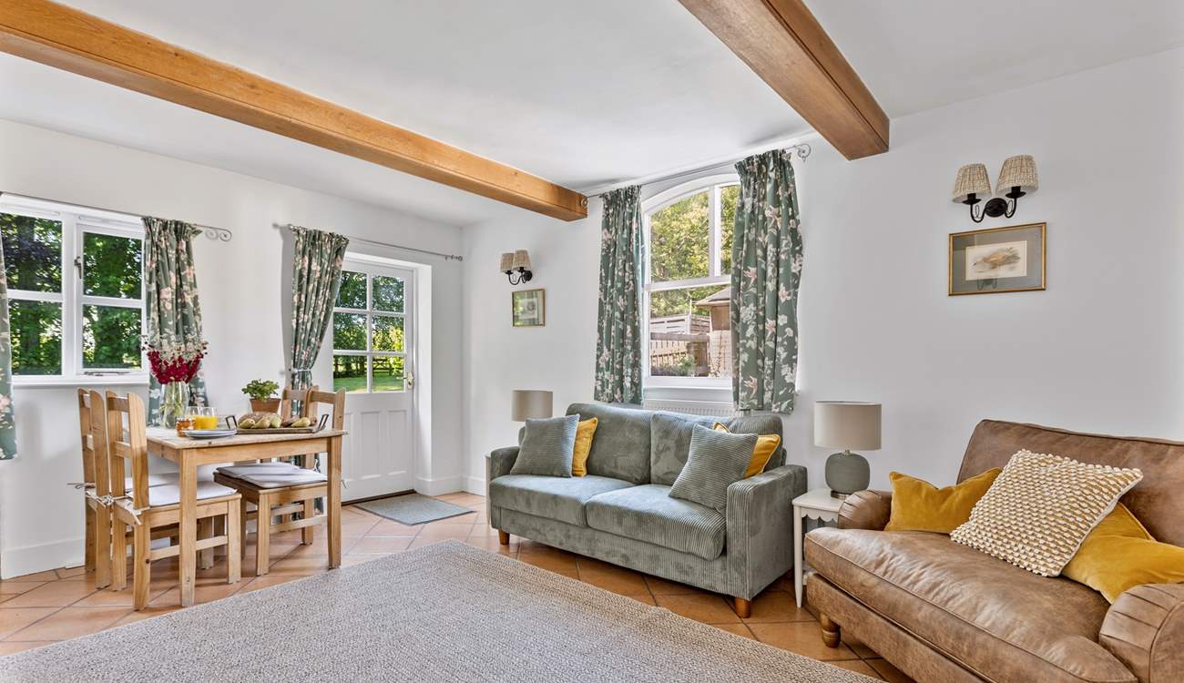 The chic dual aspect sitting-room has plenty of room for four and an intimate dining space.