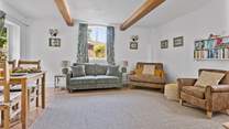 The sitting-room is a particularly lovely spot on a sunny day with the door open to the garden...