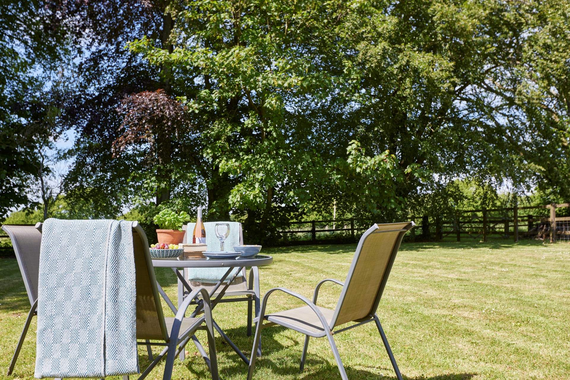 The lovely outdoor table and seating come with a parasol for some relaxing in the shade.