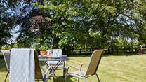 The lovely outdoor table and seating come with a parasol for some relaxing in the shade.