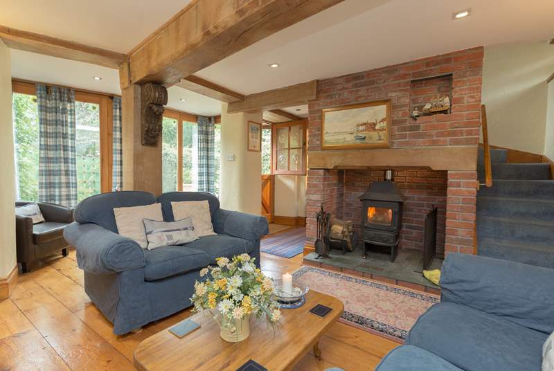 The living-room is so cosy with its wood-burning stove and comfortable sofas.