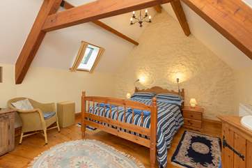 This is the lofty master bedroom. A lovely spacious room.