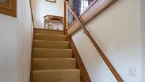 The stairs lead up into the sitting-room.