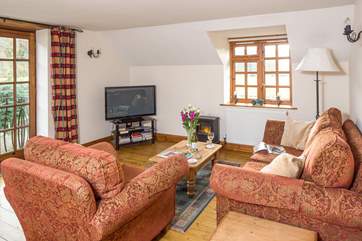Cuddle up on the sofa to watch a late film on the television.