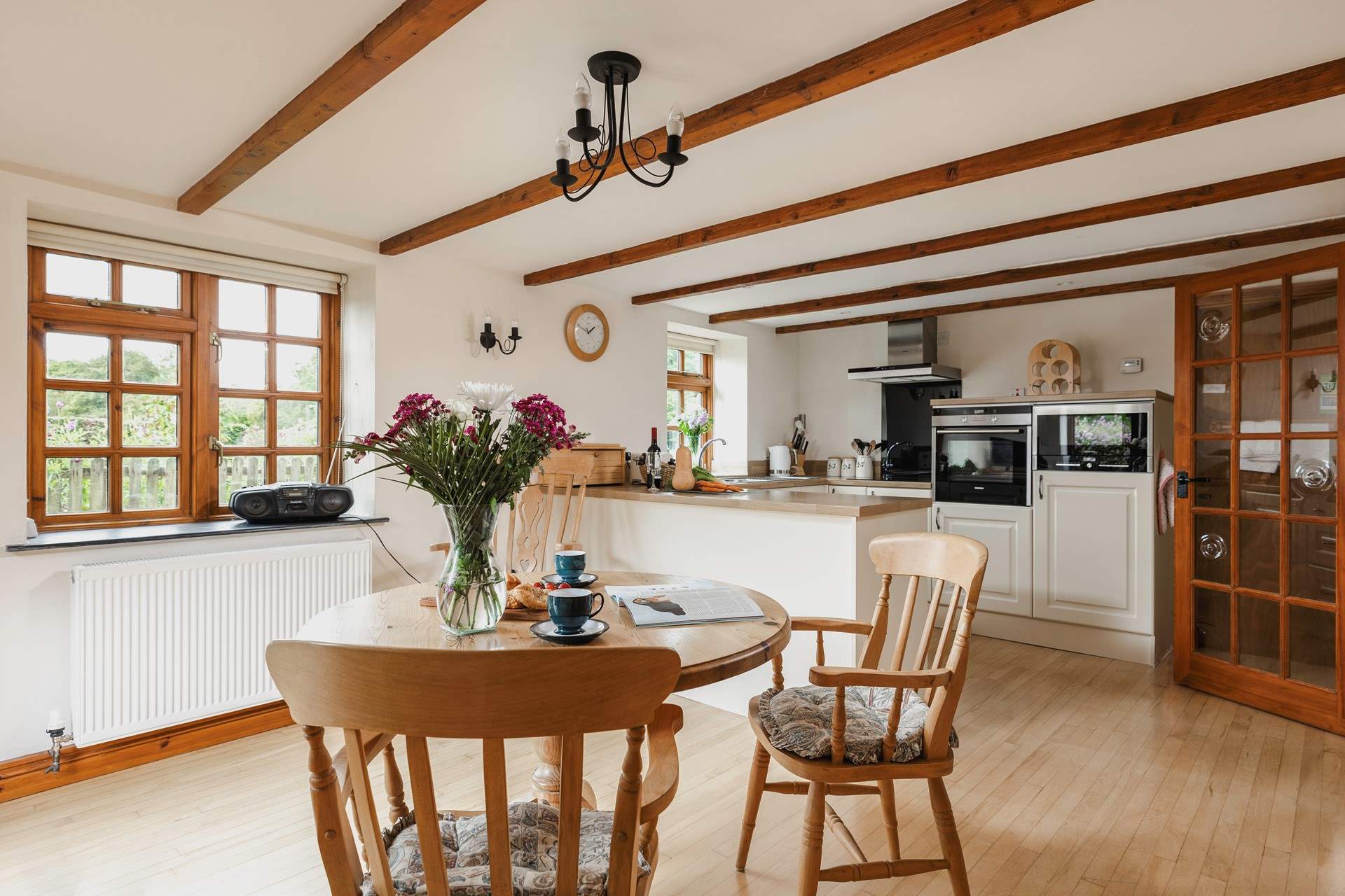The spacious kitchen/diner with a door up to the sitting area and bedroom.