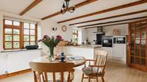 The spacious kitchen/diner with a door up to the sitting area and bedroom.