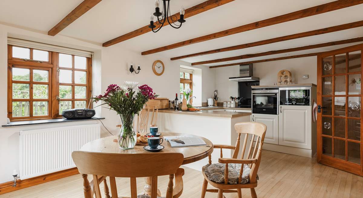 The spacious kitchen/diner with a door up to the sitting area and bedroom.