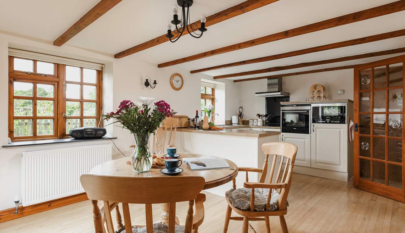 The spacious kitchen/diner with a door up to the sitting area and bedroom.