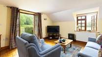 Cuddle up on the sofa to watch a film on the television.