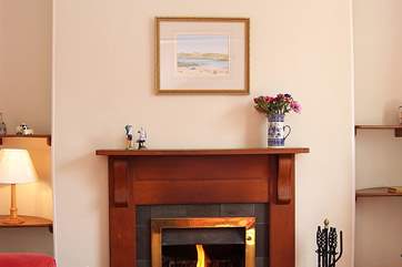 The open fire is the warming focal point of the room.