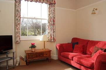 The sitting-room looks out over the enclosed garden to the front of the cottage.