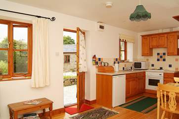 The kitchen and dining areas in the open plan living-room.
