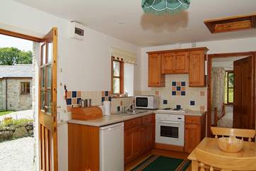The kitchen and dining-area, with the bedroom beyond.