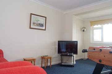 There are two sofas and a TV and DVD player in the games-room.