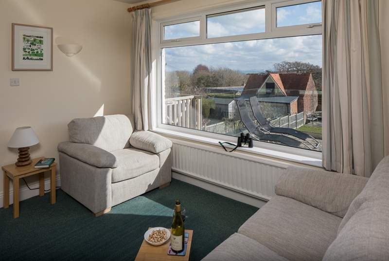 The sitting-room shares the panoramic view of the countryside with the sea beyond and the Isle of Wight on a clear day.