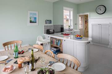 The spacious kitchen has all the equipment you could need; the utility-area is behind, with the back door in between.