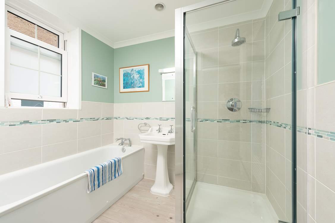 The family bathroom is super flexible with a bath and shower cubicle. Note that there are 2 steps down into the bathroom