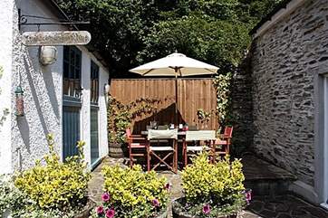 The sheltered patio is perfect for al fresco meals. (The games-room is shown on the left.)