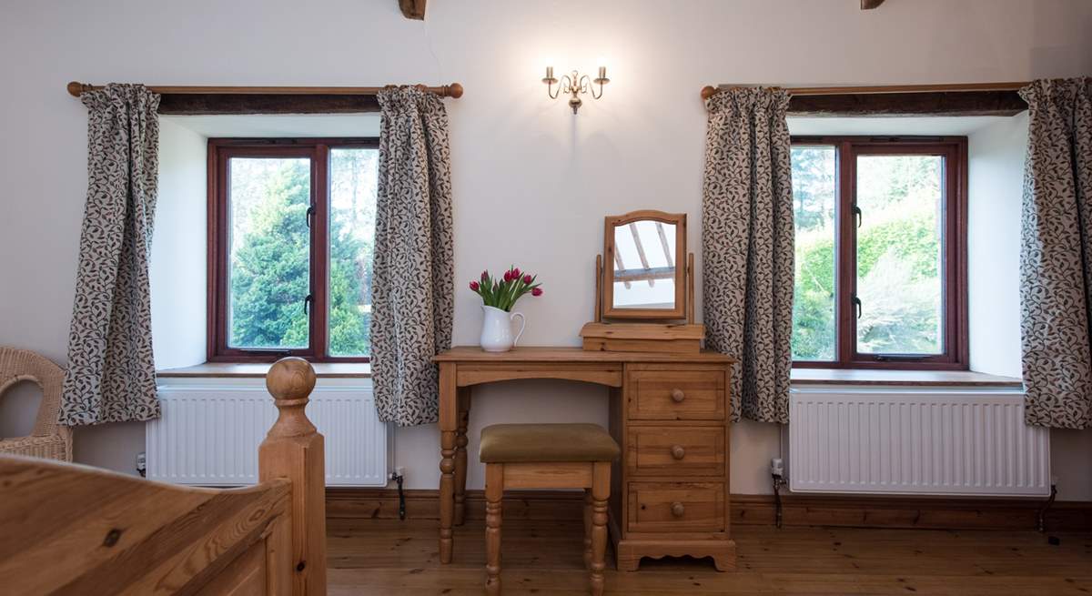 Windows look out over the garden from Bedroom 2.