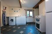 The utility-room has an electric cooker, washing machine and fridge/freezer, plus a shower-room and separate WC.