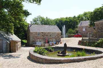 Looking towards Orchard Barn across the pond in the shared courtyard.