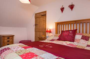 The double bedroom has a lovely wooden bedframe.