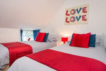 The bright twin bedded room.