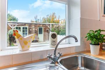 From the kitchen you can look out to the patio-area at the back of the cottage.