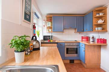The cute kitchen is very well-equipped.
