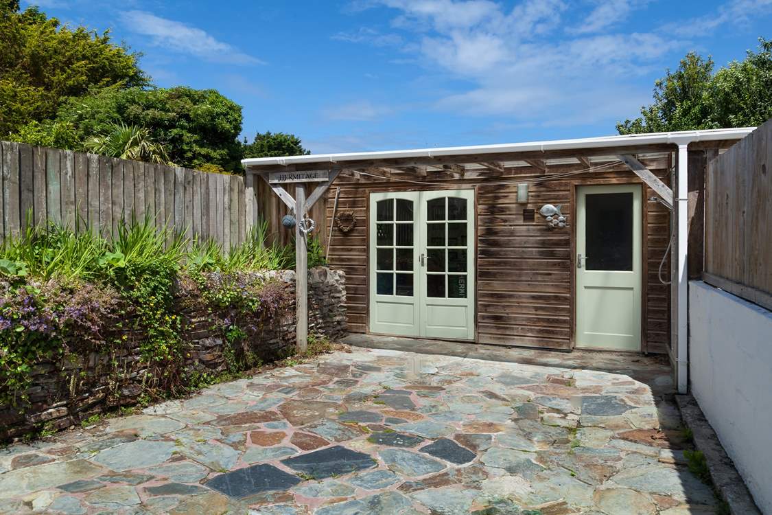 The sunny rear terrace, with a fabulous outside shower. Perfect to wash off the sand after a day on the beach.